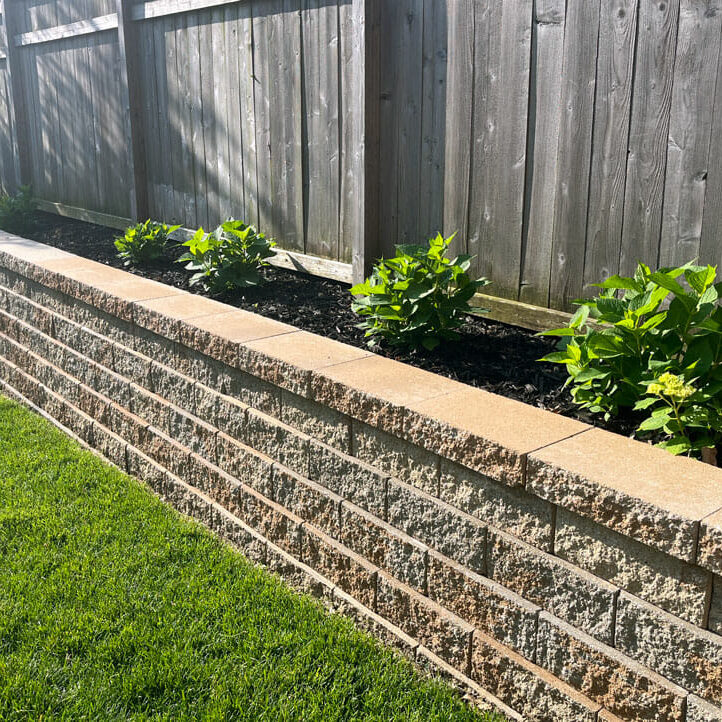 A stone garden wall with fence landscaping work Levels Bridgwater